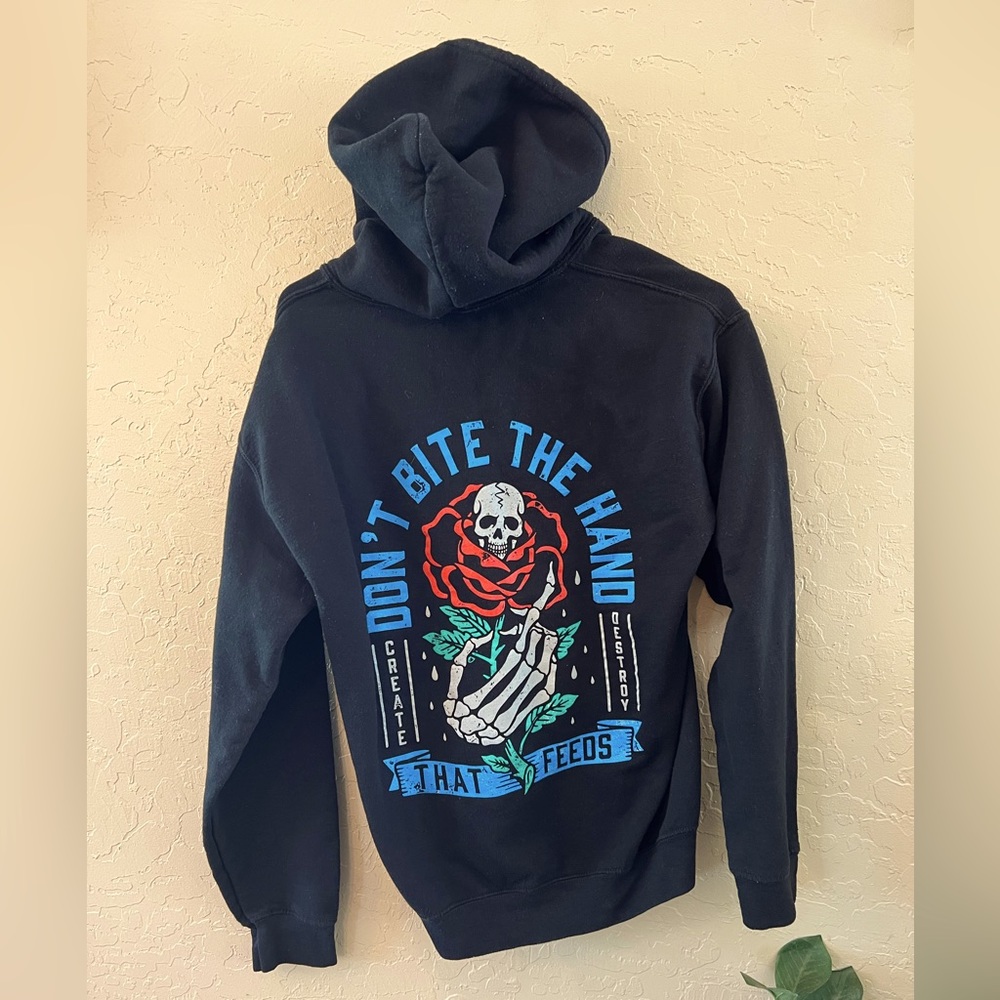 skull hoodie “ don’t bite the hand that feeds “